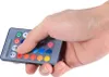 A hand holding a remote control for RGB LED lights. Voir les images du produit