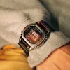 A close-up shot of a person's wrist wearing a G-Shock watch, with a grey sweatshirt sleeve visible. Produktbild-Vorschau