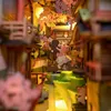 A miniature diorama of a street scene with cherry blossoms and traditional Japanese architecture. Náhled obrázku produktu