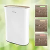 A white air purifier with a gold top is shown next to three inset images displaying different air quality indicators and control panel settings. Produktbild-Vorschau