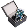 An open black box containing a smartphone and car keys. Produktbild-Vorschau