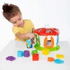 A young child is playing with a shape sorter toy. Produktbild-Vorschau