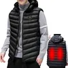 A man wearing a black heated vest over a grey turtleneck sweater. A smaller inset image shows the back of the vest with red heat zones. Náhľad obrázku produktu