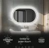 A modern bathroom with an illuminated oval mirror above a sink. Produktbild-Vorschau