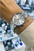 A close-up shot of a woman's wrist wearing a silver Casio watch and a delicate bracelet. Produktbild-Vorschau
