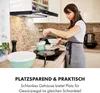 A woman is cooking in a kitchen, with a range hood above the stove. Produktbild-Vorschau