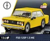 A yellow toy car model on a dark reflective surface with a dark background. Produktbild-Vorschau