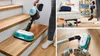 A collage of images showing a Bosch cordless vacuum cleaner being used on stairs, in a living room, and on a wooden floor near toys. Produktbild-Vorschau