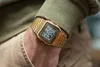 A close-up shot of a person's wrist wearing a gold Casio digital watch. Produktbild-Vorschau