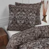 A bedding set with a damask pattern is displayed on a bed. Produktbild-Vorschau