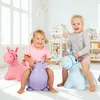 Two young children are happily playing on inflatable hopping animals in a bright, indoor playroom. Anteprima dell’immagine prodotto