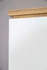 A close-up view of the top corner of a white cabinet with a wooden trim. Produktbild-Vorschau