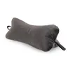 A dark gray, bone-shaped pillow is shown against a white background. Produktbild-Vorschau
