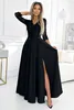 A woman is posing in a black dress in a well-lit room. Anteprima dell’immagine prodotto