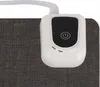 A close-up view of a white electronic control unit with a black power button on a gray textured surface. Produktbild-Vorschau