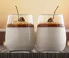 Two glasses of panna cotta with caramel sauce and a garnish. Produktbild-Vorschau
