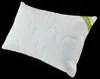 A white pillow with a quilted pattern and a green label on the corner. Podgląd zdjęcia produktu
