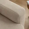 Close-up view of the armrest and seat cushion of a beige sofa. Anteprima dell’immagine prodotto