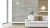 A modern living room with a white sofa, concrete wall, and a small white ventilation unit mounted on the wall. Náhľad obrázku produktu