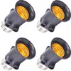 Four black light bulb socket extenders with gold-colored interiors are arranged in a grid pattern against a white background. Náhľad obrázku produktu