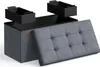 A storage ottoman with two pull-out drawers and a tufted lid is shown against a white background. Produktbild-Vorschau