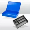 A blue metal toolbox is open, and a gray plastic organizer tray is placed in front of it. Produktbild-Vorschau