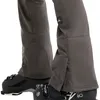 Close-up of the lower legs of ski pants worn over ski boots. Produktbild-Vorschau