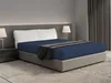 A bedroom scene with a bed made with a blue fitted sheet and a dark gray throw blanket. Produktbild-Vorschau