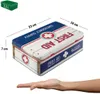 A first aid tin box with dimensions indicated, placed on a white background with a hand underneath. Podgląd zdjęcia produktu