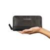 A hand holding a wallet. Produktbild-Vorschau