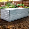 A raised garden bed in a garden setting with plants in the background. Produktbild-Vorschau