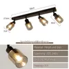 A black four-light ceiling spotlight fixture with glass shades, shown with dimensions and product specifications. Anteprima dell’immagine prodotto