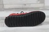 The sole of a red shoe is shown against a light-colored, wood-plank-like background. Produktbild-Vorschau