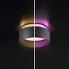 A split image showing a ceiling light fixture with different colored lighting effects. Produktbild-Vorschau