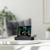 A digital weather station sits on a white table in a living room setting. Produktbild-Vorschau
