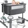 A baby in a bedside crib with a teddy bear. Produktbild-Vorschau