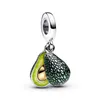 A silver charm shaped like an avocado, split in half, with one half showing the pit and flesh, and the other half showing the textured skin. Voir les images du produit