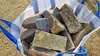 A large white bag filled with natural stone blocks. Produktbild-Vorschau