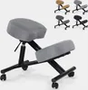 A gray ergonomic kneeling chair with a black metal frame is shown against a white background. Several other chairs in different colors are visible in the upper right corner. Produktbild-Vorschau