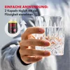 A person is holding a glass of water next to a bottle of Alpha Beast capsules, with text overlay indicating usage instructions. Produktbild-Vorschau