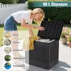 A woman is putting items into a black storage box outdoors. Voir les images du produit