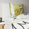 A close-up view of a bed with a pillow and duvet cover. Anteprima dell’immagine prodotto
