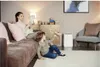 A mother and son are in a living room, with the son playing with a toy airplane and the mother reading a tablet. Voir les images du produit