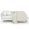 A white wooden bed with pillows and a beige blanket, shown from the side against a white background. Náhled obrázku produktu