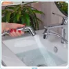 A hand holding a bidet sprayer over a sink, with water spraying into the sink. Anteprima dell’immagine prodotto