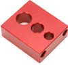 A red metal jig with three holes of different sizes on its top surface and two holes on its side. Náhľad obrázku produktu