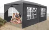 A couple enjoying a picnic under a dark grey party tent on a beach. Náhled obrázku produktu