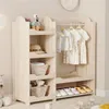 A children's wardrobe with a hanging rail and shelves, displaying clothes, a hat, and baskets. Anteprima dell’immagine prodotto