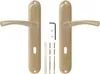 A pair of bronze door handles with their accompanying hardware, laid out on a white background. Produktbild-Vorschau