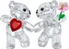 Two crystal teddy bears are shown, one holding a red heart and the other holding a pink flower. Produktbild-Vorschau